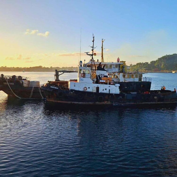 Tugboat Warringa leads the LC Sarafenua on her final voyage from Port Vila to Luganville, Santo.
