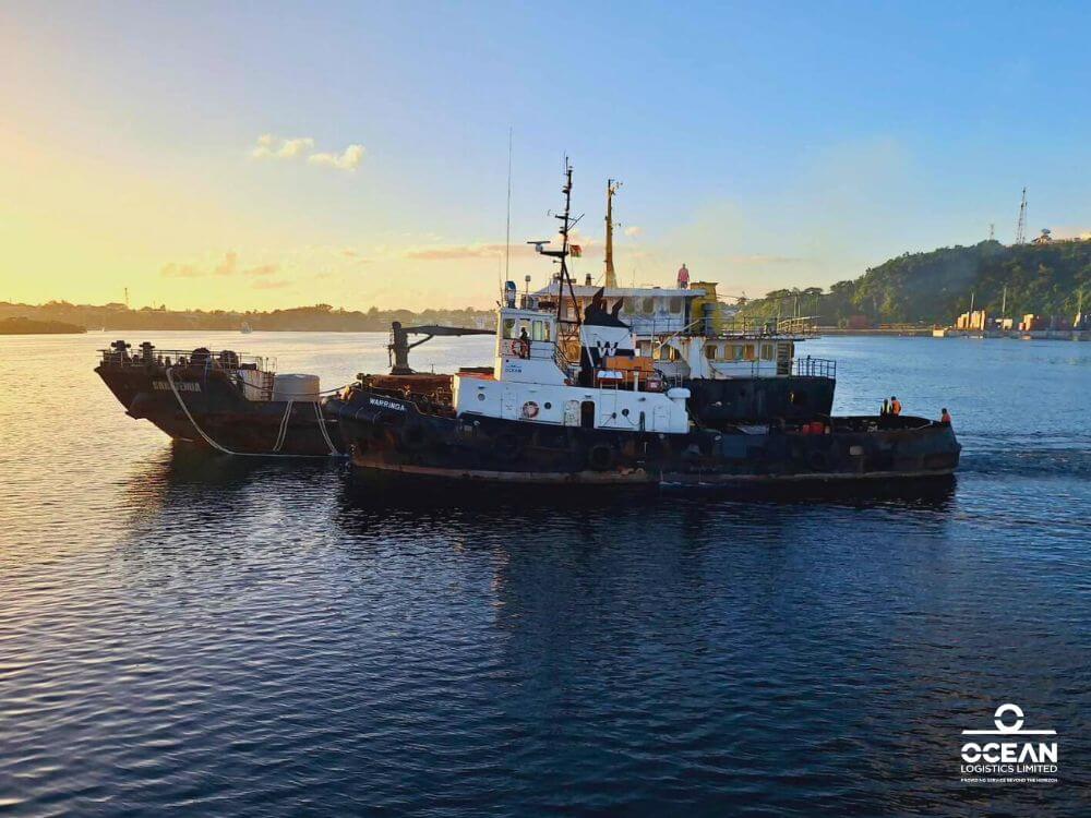 Tugboat Warringa leads the LC Sarafenua on her final voyage from Port Vila to Luganville, Santo.